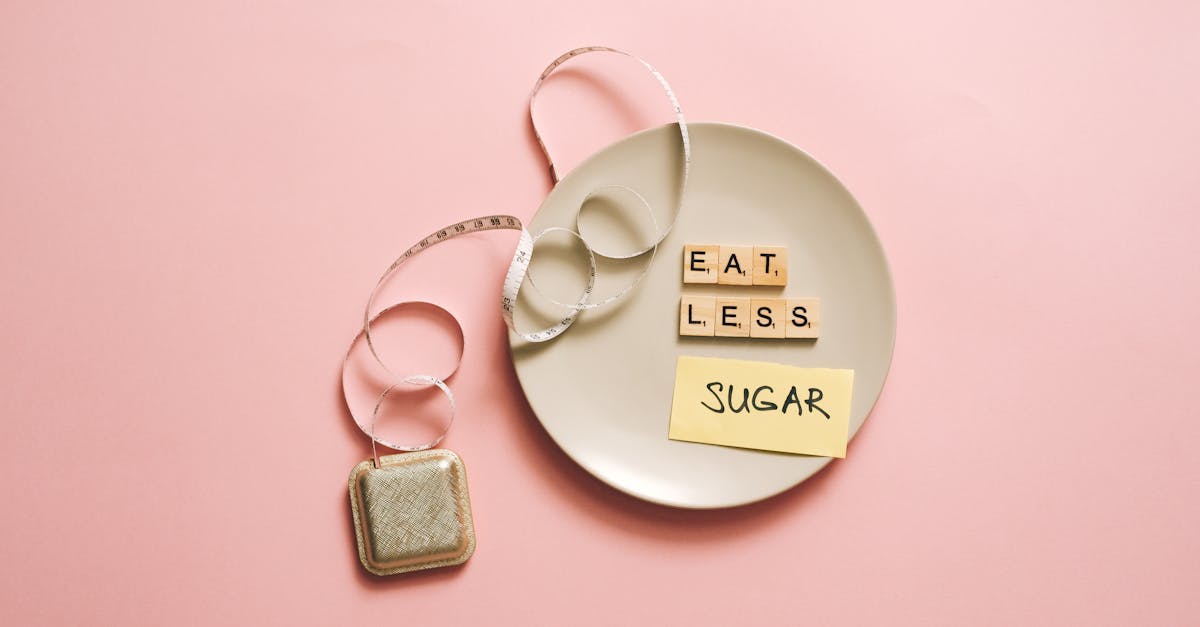 Flat lay of a plate with scrabble tiles spelling 'Eat Less Sugar,' accompanied by a tape measure, symbolizing healthy eating.